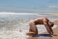 naked-bodybuilder-on-his-hands-and-knees-at-the-ocean.jpg